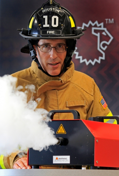 Steve Schwartz ’84 in firefighting gear with a smoke simulator.